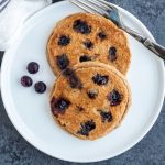 Blueberry Almond Pancakes on a white plate.