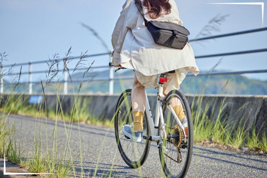 A woman riding a bike outside.